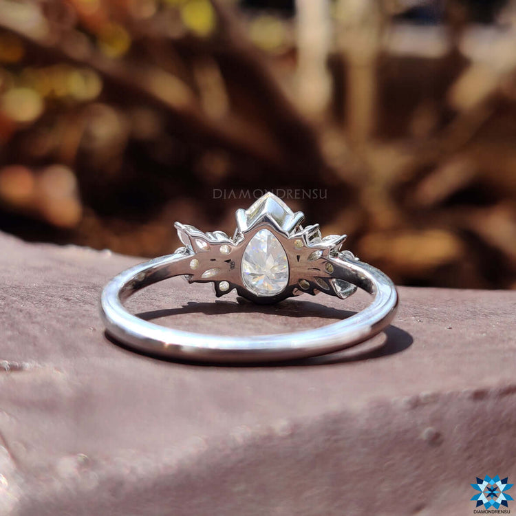 Pear shape moissanite ring with 4 claw prong setting.
