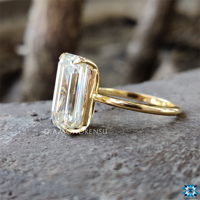 Yellow gold ring with classic solitaire setting and moissanite stone.
