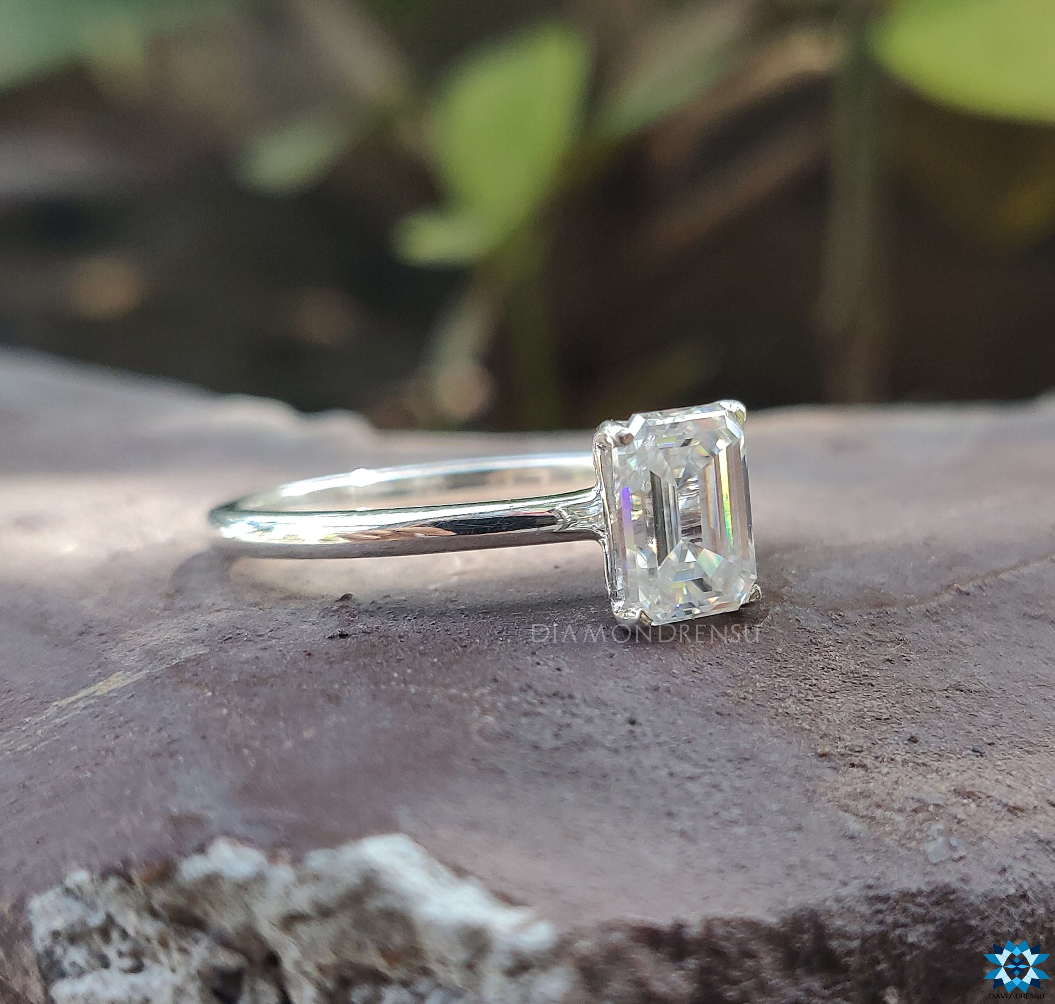 Moissanite solitaire ring featuring a brilliant emerald cut stone for a radiant sparkle.
