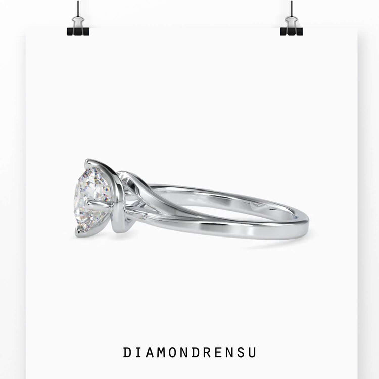 Custom engagement ring with 4 prong round diamond in bypass style.
