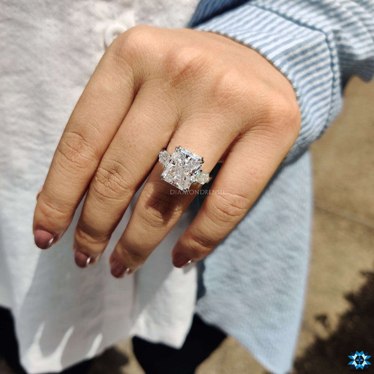 Radiant cut moissanite ring with tapered bullet side stones.
