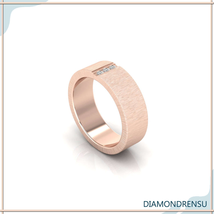 Yellow gold brushed finish wedding band with men's baguette diamond wedding band.
