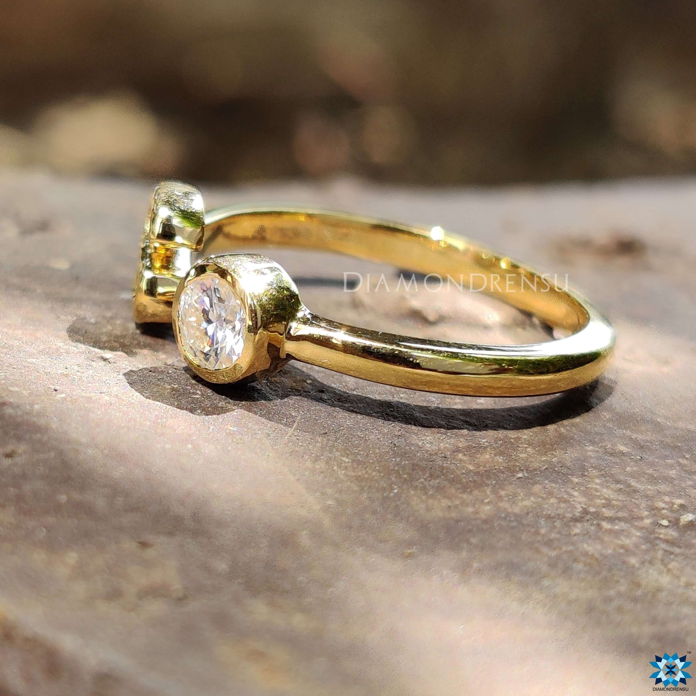 Custom ring design featuring a round cut moissanite ring and yellow gold band.