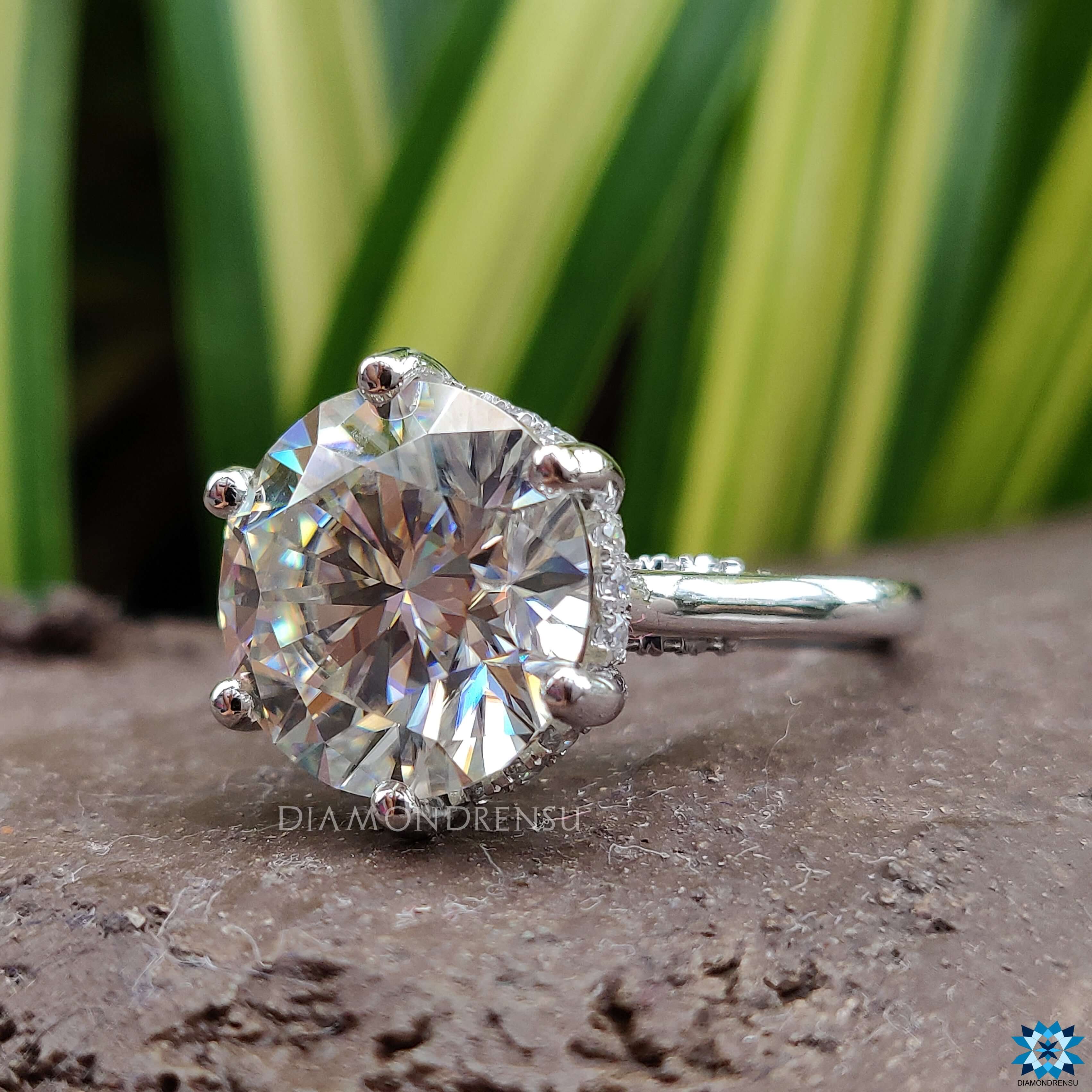 Round cut moissanite ring set in a beautiful hidden halo ring for maximum sparkle.