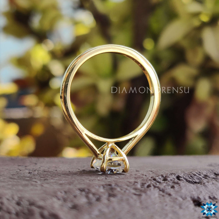 Timeless cushion cut moissanite solitaire crafted in solid yellow gold.
