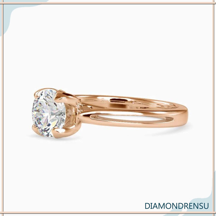 Yellow gold ring featuring a petal setting and solitaire stone.
