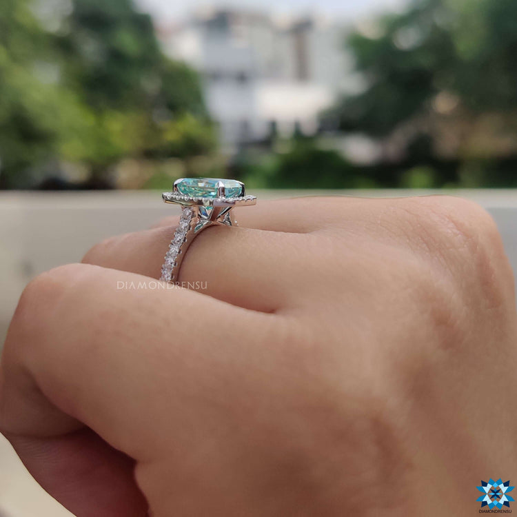 Radiant cut blue moissanite ring in claw prong mount.
