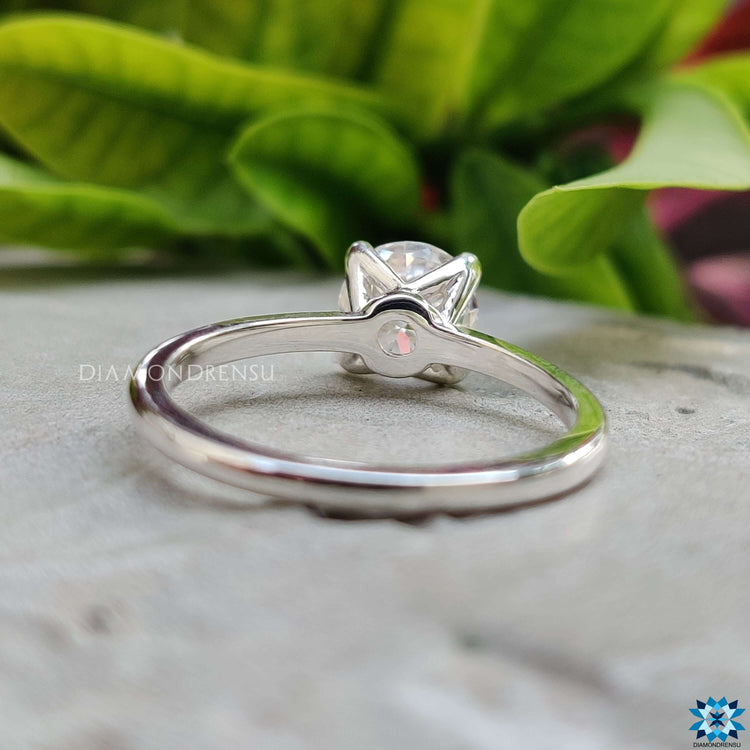 Custom solitaire ring with round cut moissanite.
