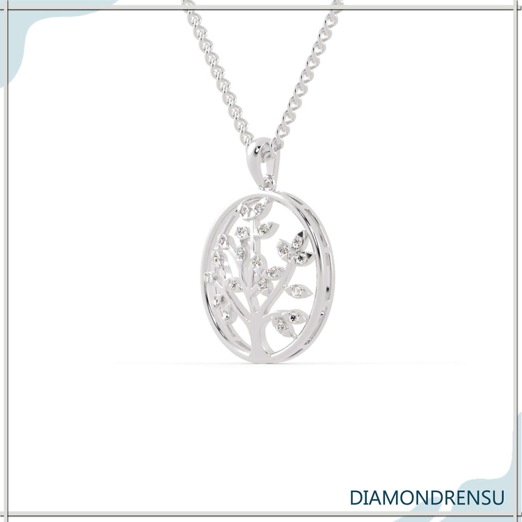 Round diamond pendant featuring symbolic tree of life design.
