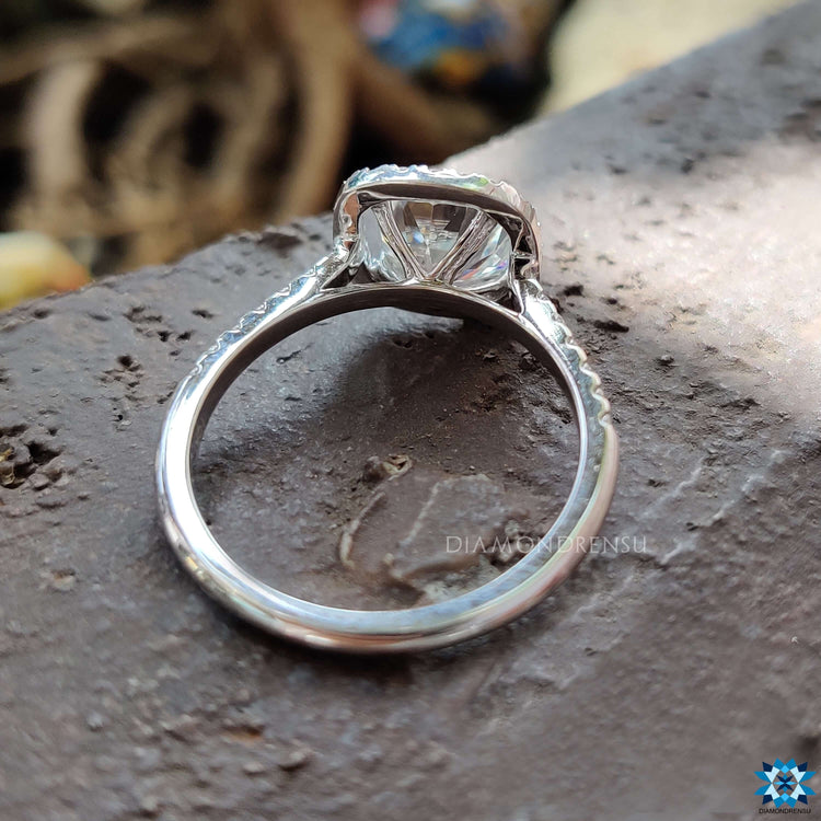 Moissanite halo ring in white gold with double prong setting.
