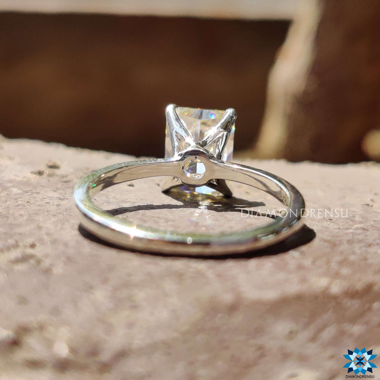 Handmade ring with radiant cut moissanite in a solitaire setting crafted in white gold.
