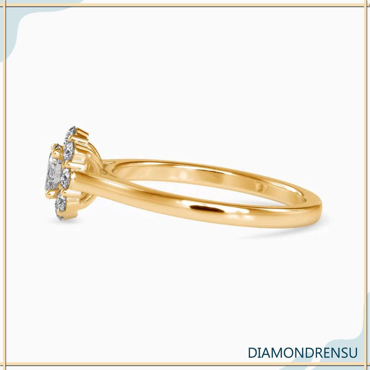 Yellow gold cluster ring with oval diamond centre and 4 prong setting.
