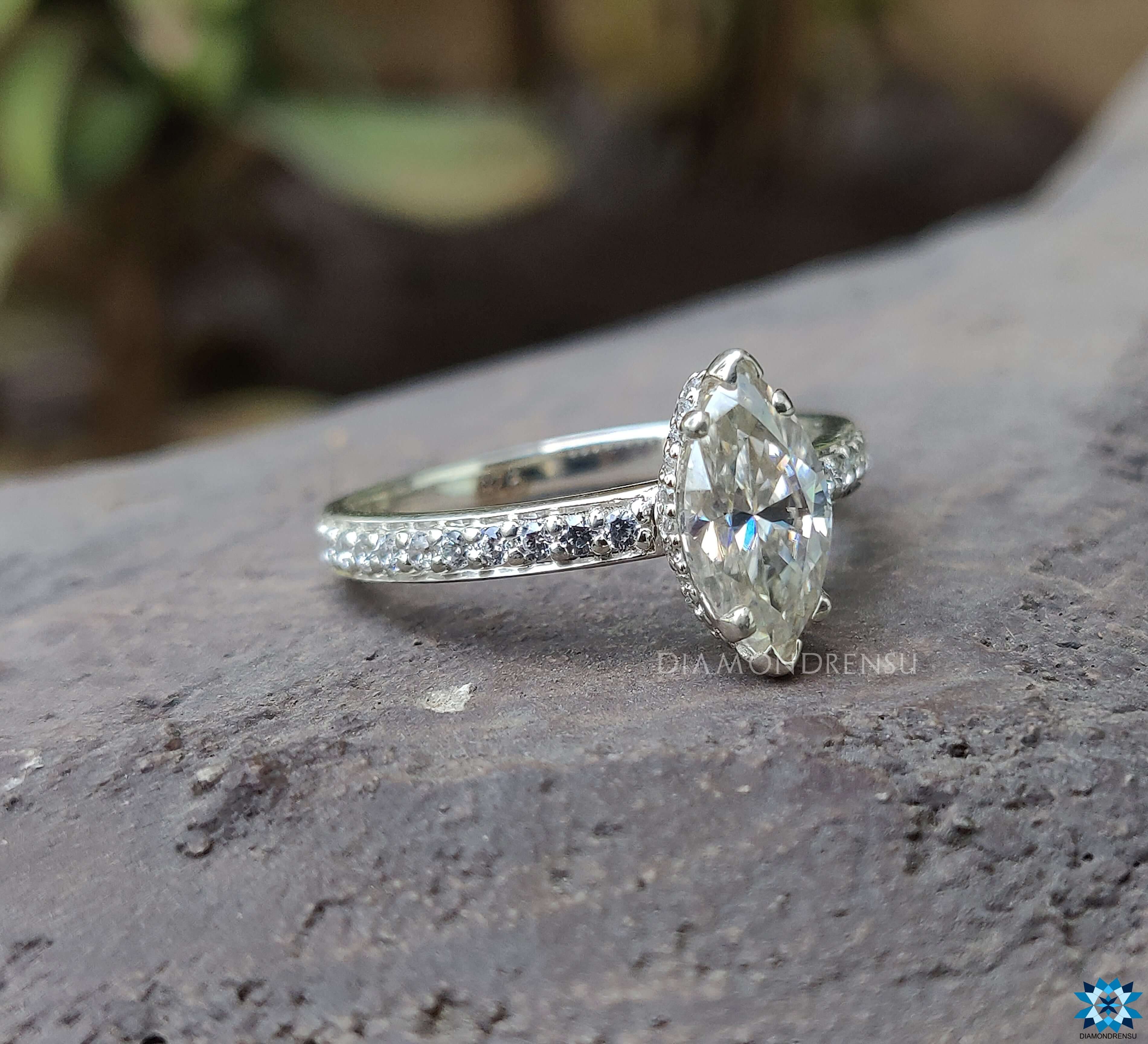 Pave setting ring with marquise Moissanite and hidden halo for added sparkle.