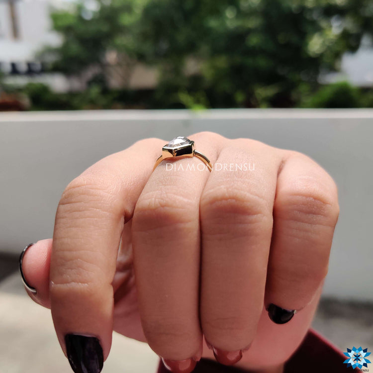 Hexagon cut solitaire ring crafted in white gold.
