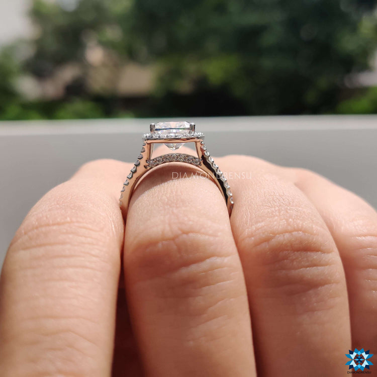 White gold cushion engagement ring with halo design.

