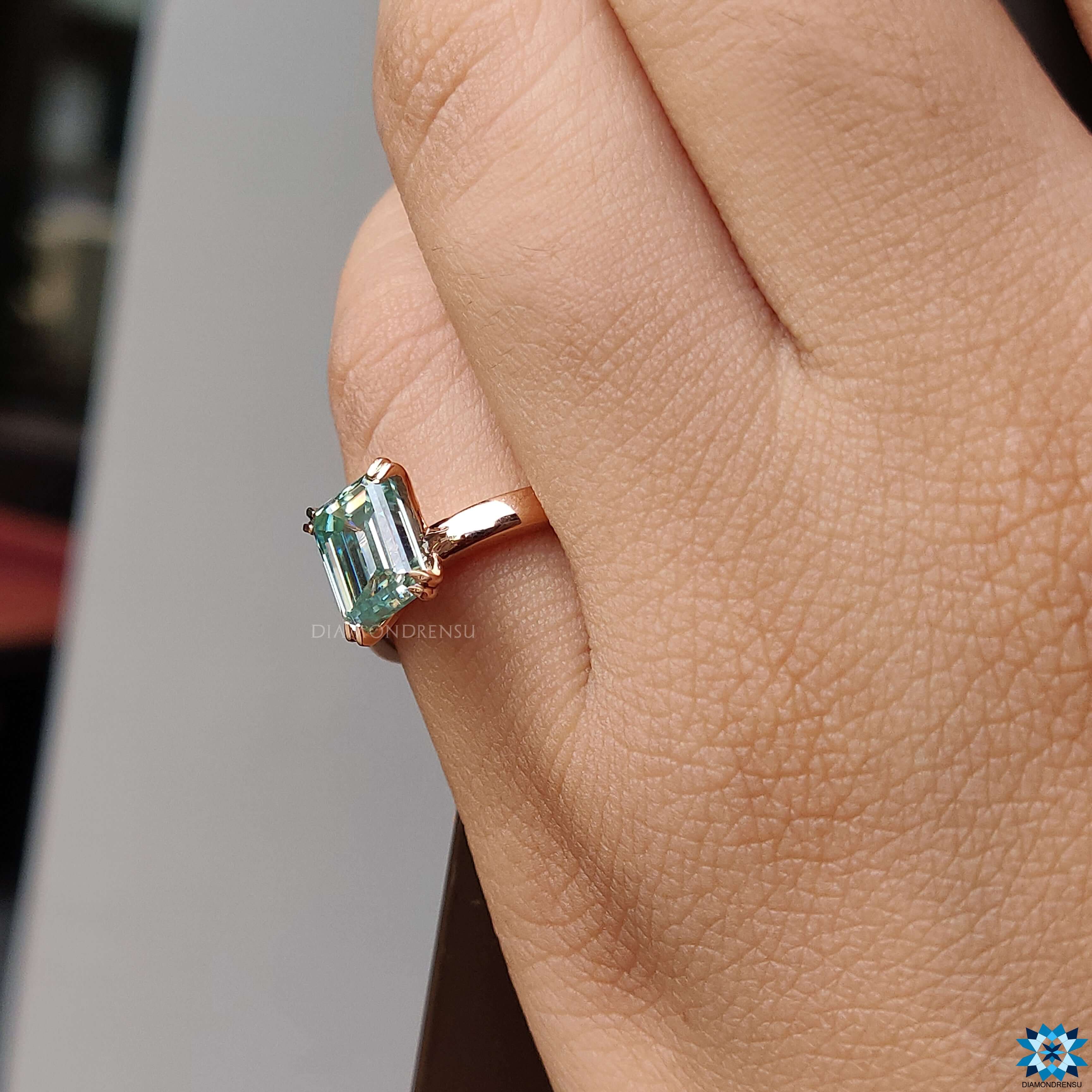 Moissanite ring UK crafted with an emerald cut moissanite stone for brilliance.