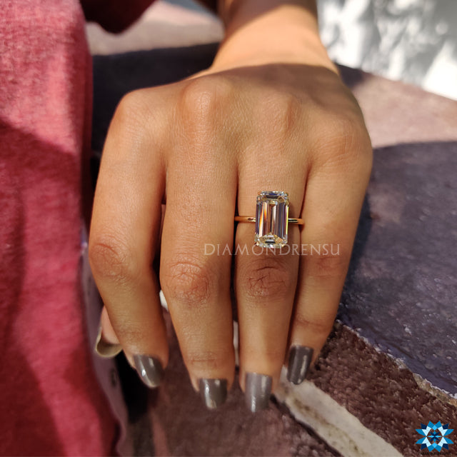 Handmade jewellery featuring emerald cut moissanite and yellow gold band.
