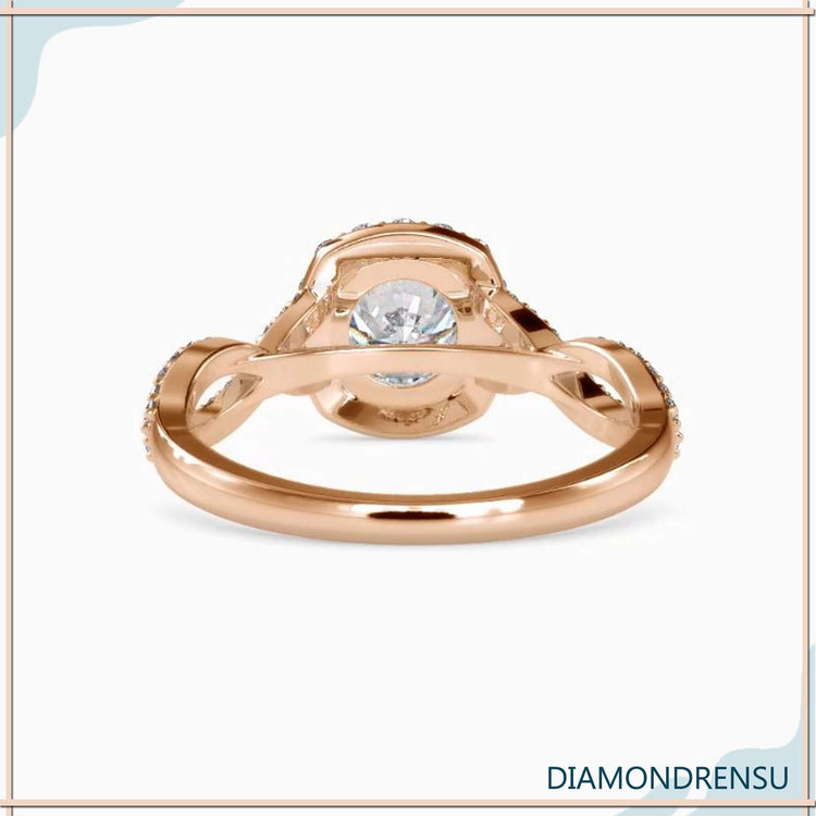 Custom engagement ring with twisted band and round diamond centre.
