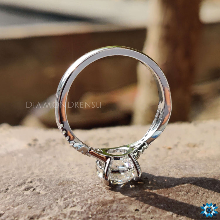 White gold moissanite ring featuring twisted pave design.
