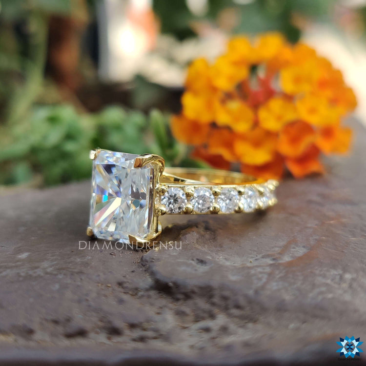 Pave engagement ring with radiant cut moissanite.
