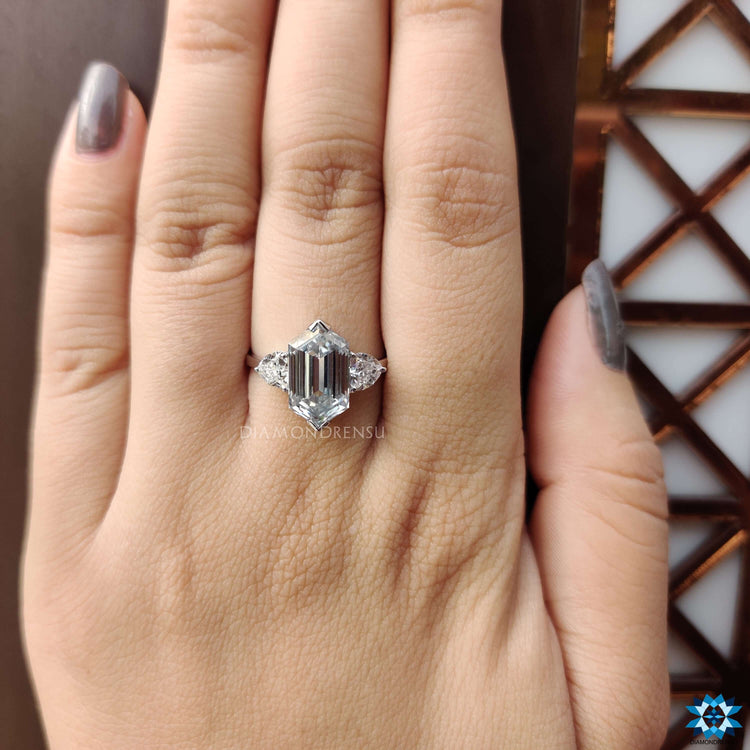 White gold three stone engagement ring with hexagon center stone.
