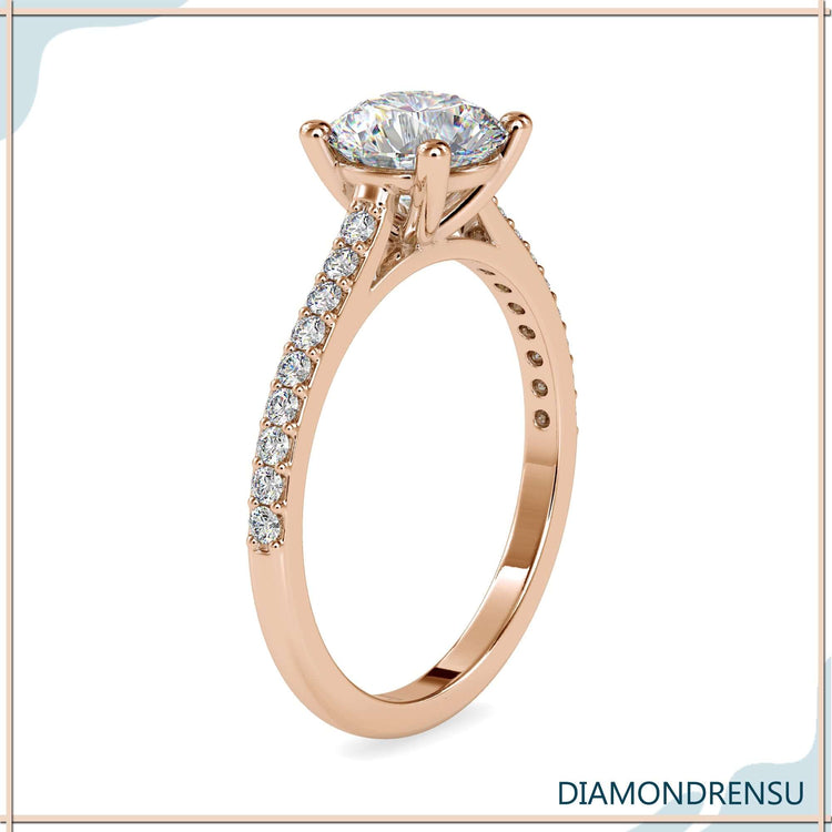 Cathedral ring in yellow gold with round cut pave band.
