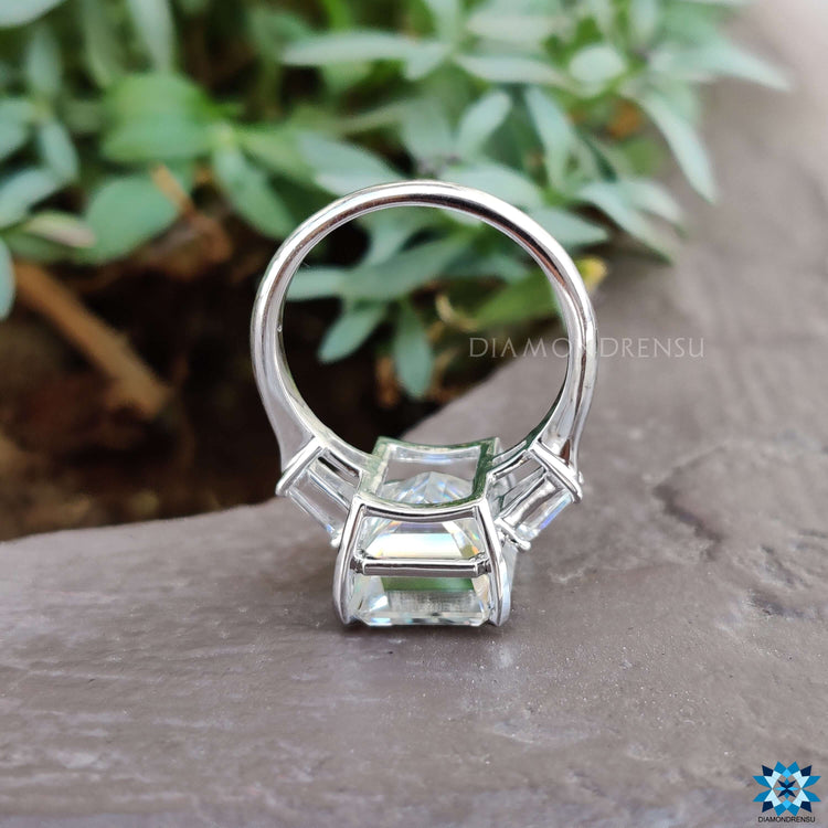 Buy custom moissanite ring with emerald center stone.
