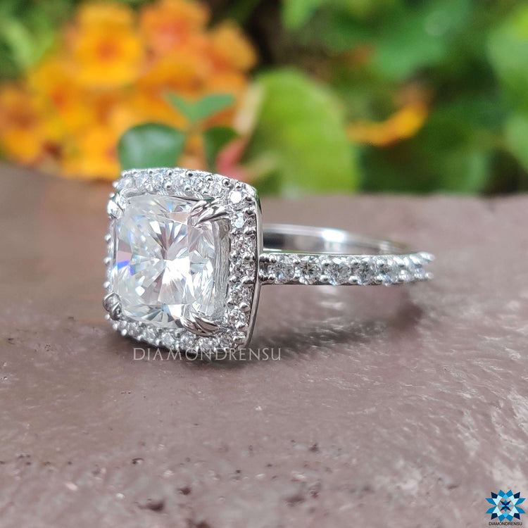 Moissanite halo ring featuring a cathedral setting design.
