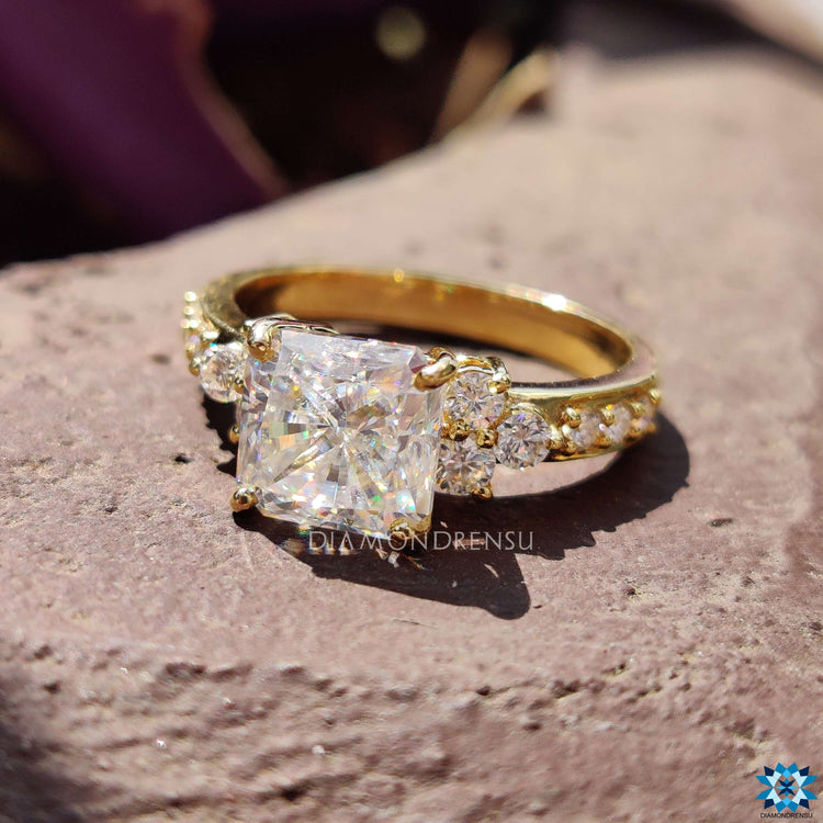 Custom engagement ring with radiant cut and round accents.
