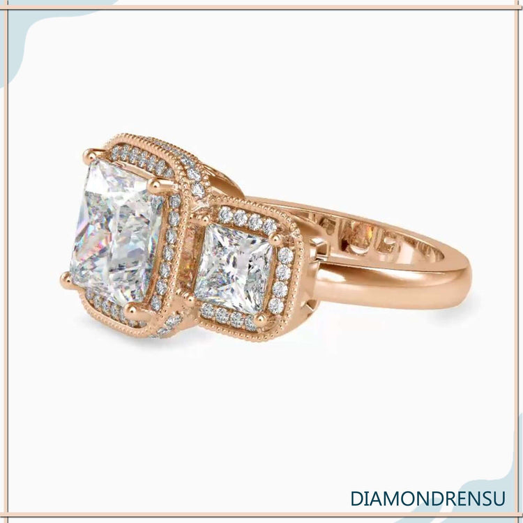 White gold engagement ring with milgrain three stone setting.
