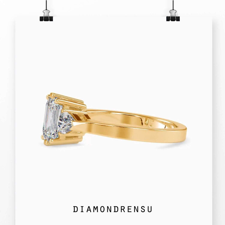 Designer ring with emerald cut diamond and side accents.
