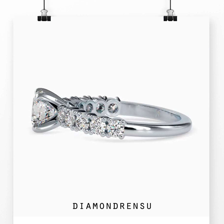 UK engagement ring with round diamond and handmade pave band.
