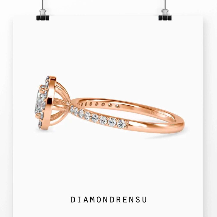 Yellow gold oval diamond engagement ring with round prongs.
