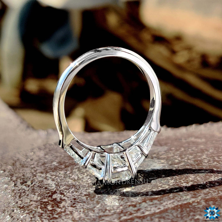 Handmade five stone ring with emerald and baguette cuts.
