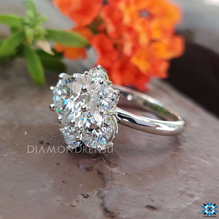 White gold moissanite ring with five round cut lab stones.
