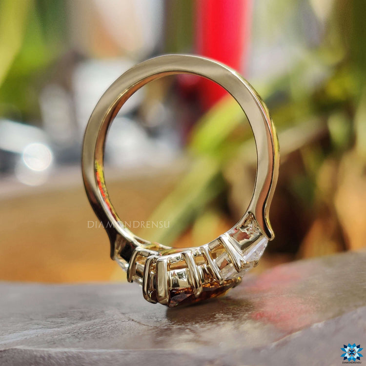 Five stone moissanite ring in yellow gold.
