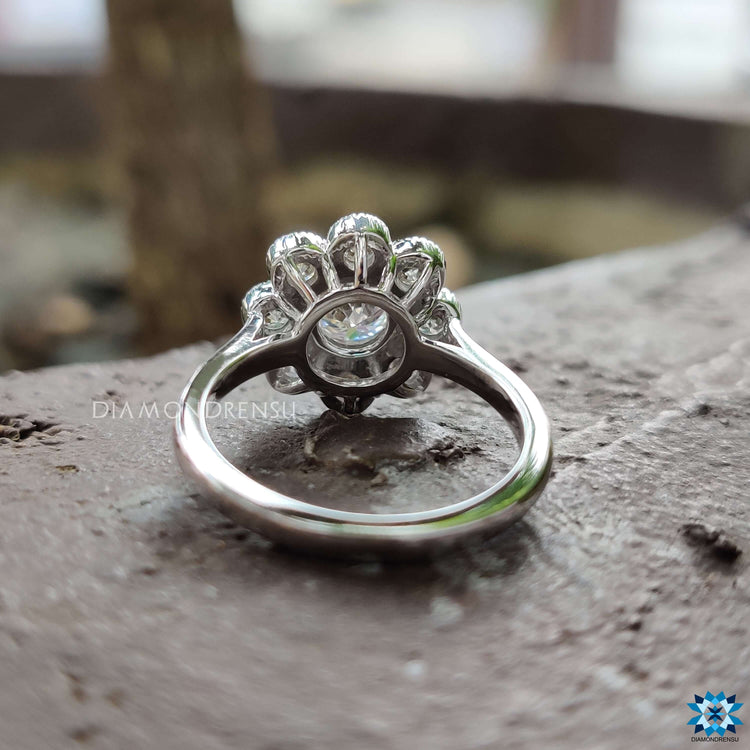 Custom moissanite engagement ring with flower-inspired bezel design.
