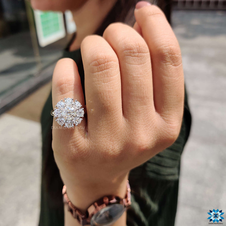 Round cut moissanite ring with cluster halo and cathedral design.

