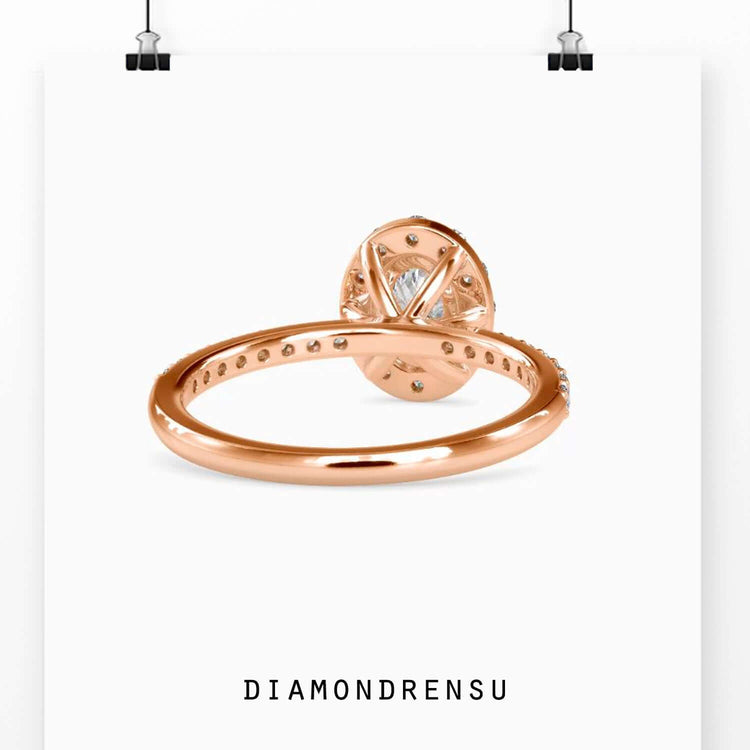 Rose gold halo ring with oval diamond and lab certificate.
