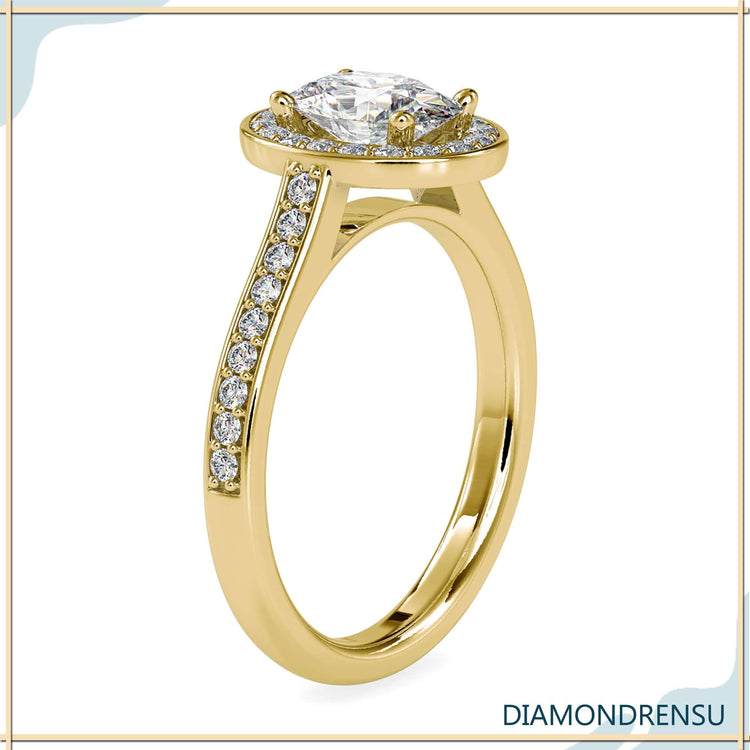 Yellow gold ring with pave setting and oval halo design.
