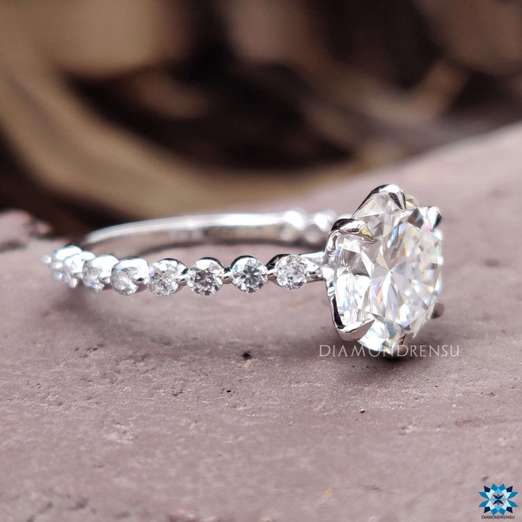 Pave setting moissanite engagement ring in a shared prong band style.
