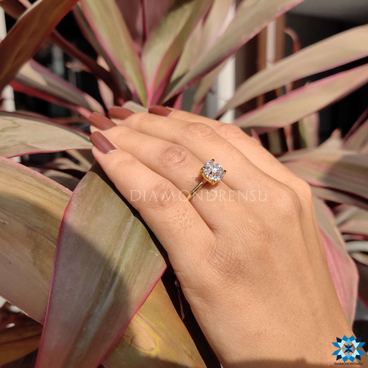 Custom round solitaire engagement ring in yellow gold.
