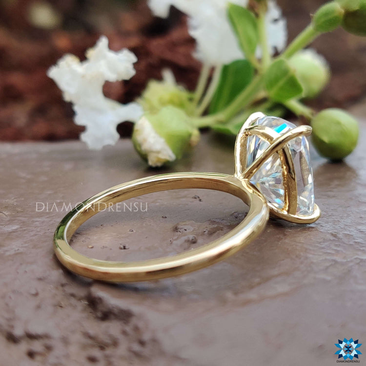 Crushed ice cushion cut moissanite ring set in yellow gold.
