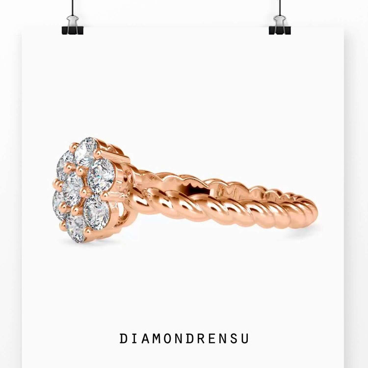 White gold twisted engagement ring with cluster halo setting.

