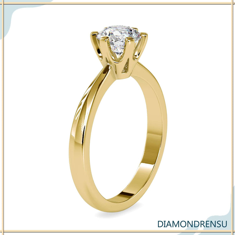 Simple diamond ring with solitaire setting and white gold band.
