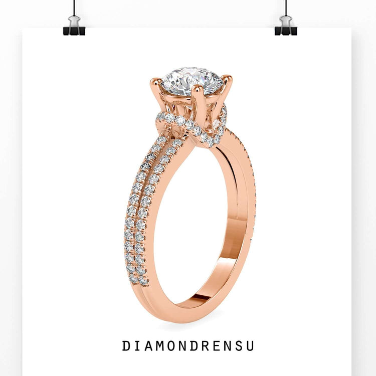 White gold engagement ring with split shank and diamond halo.
