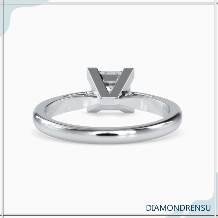 Yellow gold diamond ring with princess cut and v shaped prong setting.
