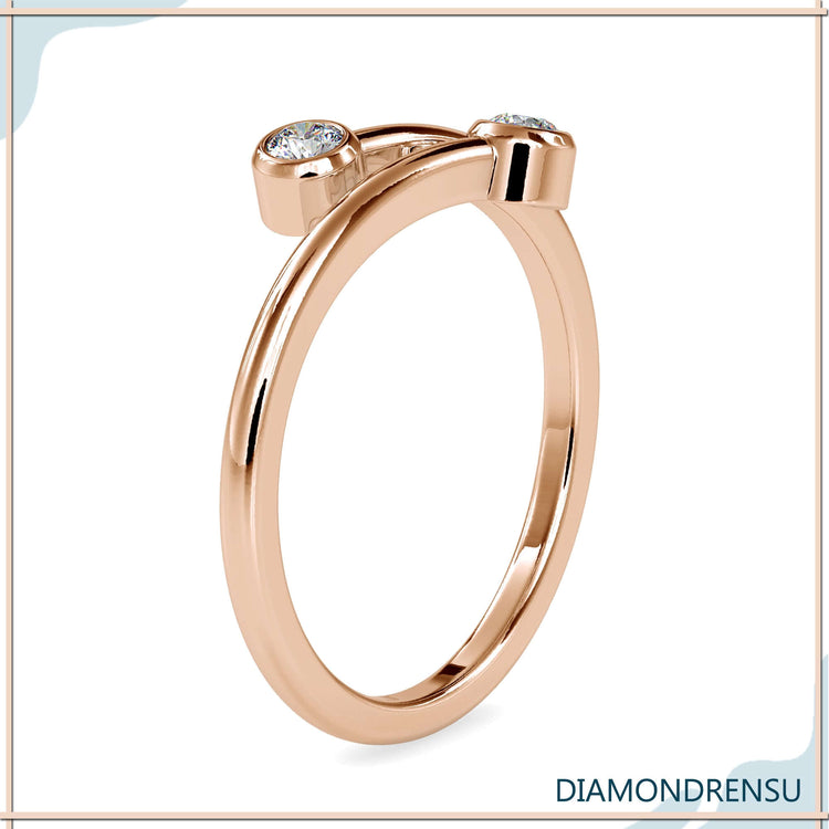 Yellow gold bypass ring featuring lab grown round diamonds.

