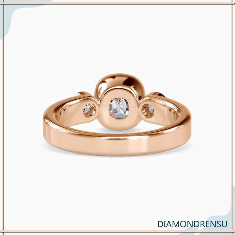 Simple diamond ring with cushion cut and round accents.
