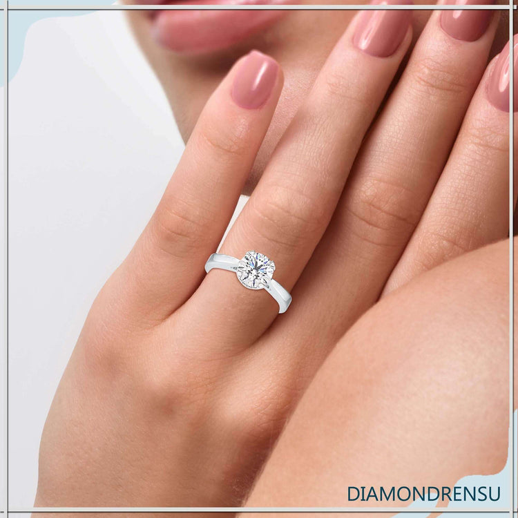 Round diamond solitaire ring with tapered shank and 4 prong setting.
